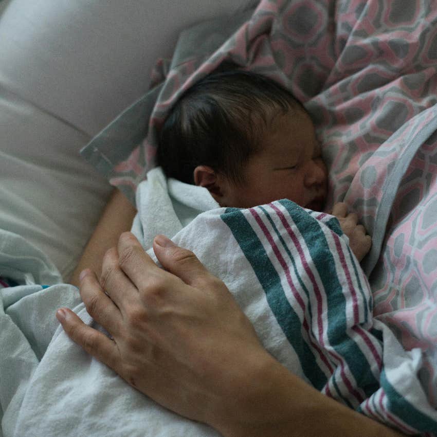 mom holding her newborn baby in the hospital