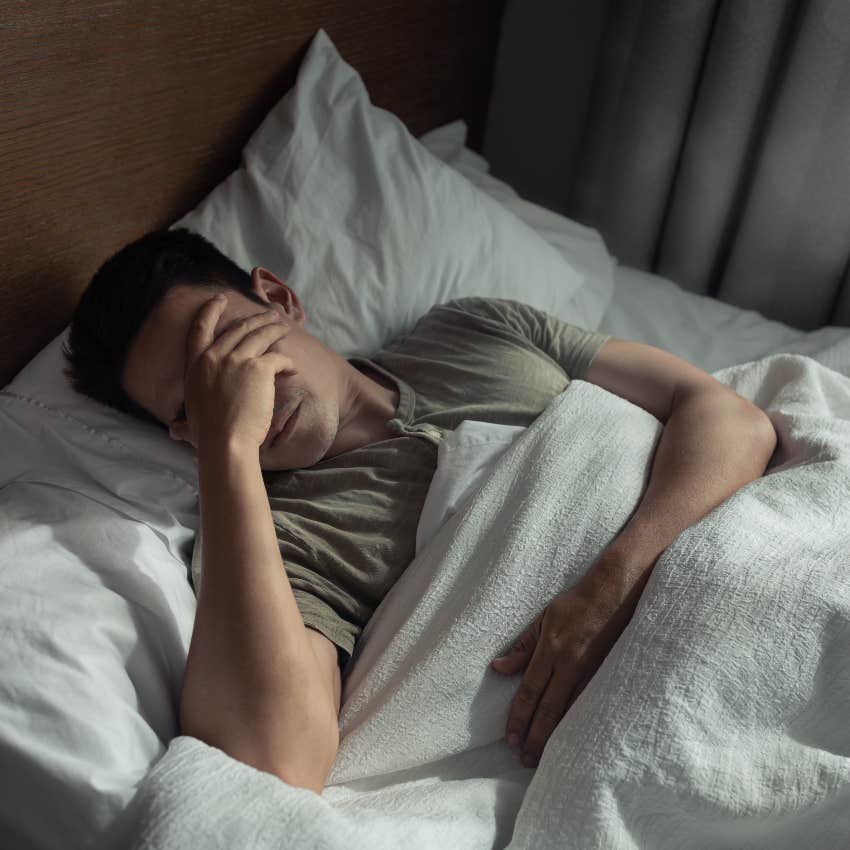 man with insomnia laying in bed sleep impact biological aging
