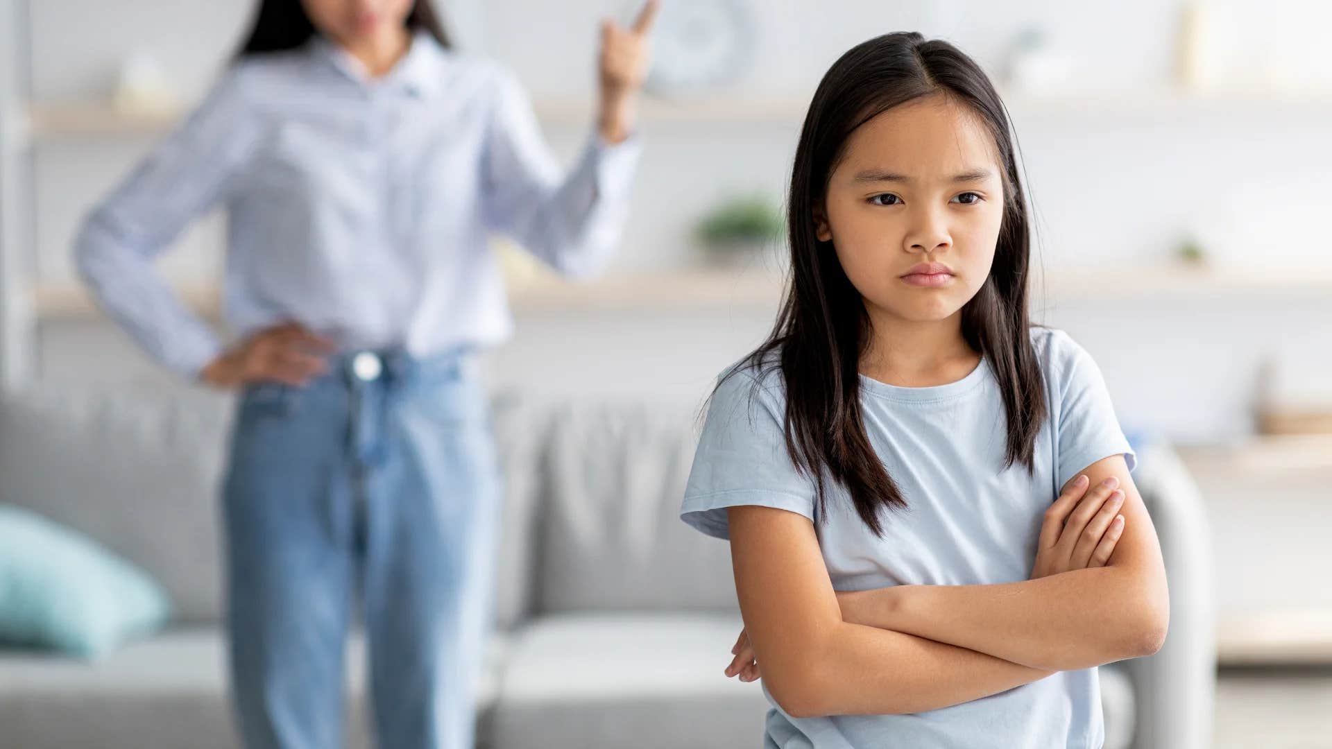 young girl turned away from mom punishing her saying you brought this on yourself