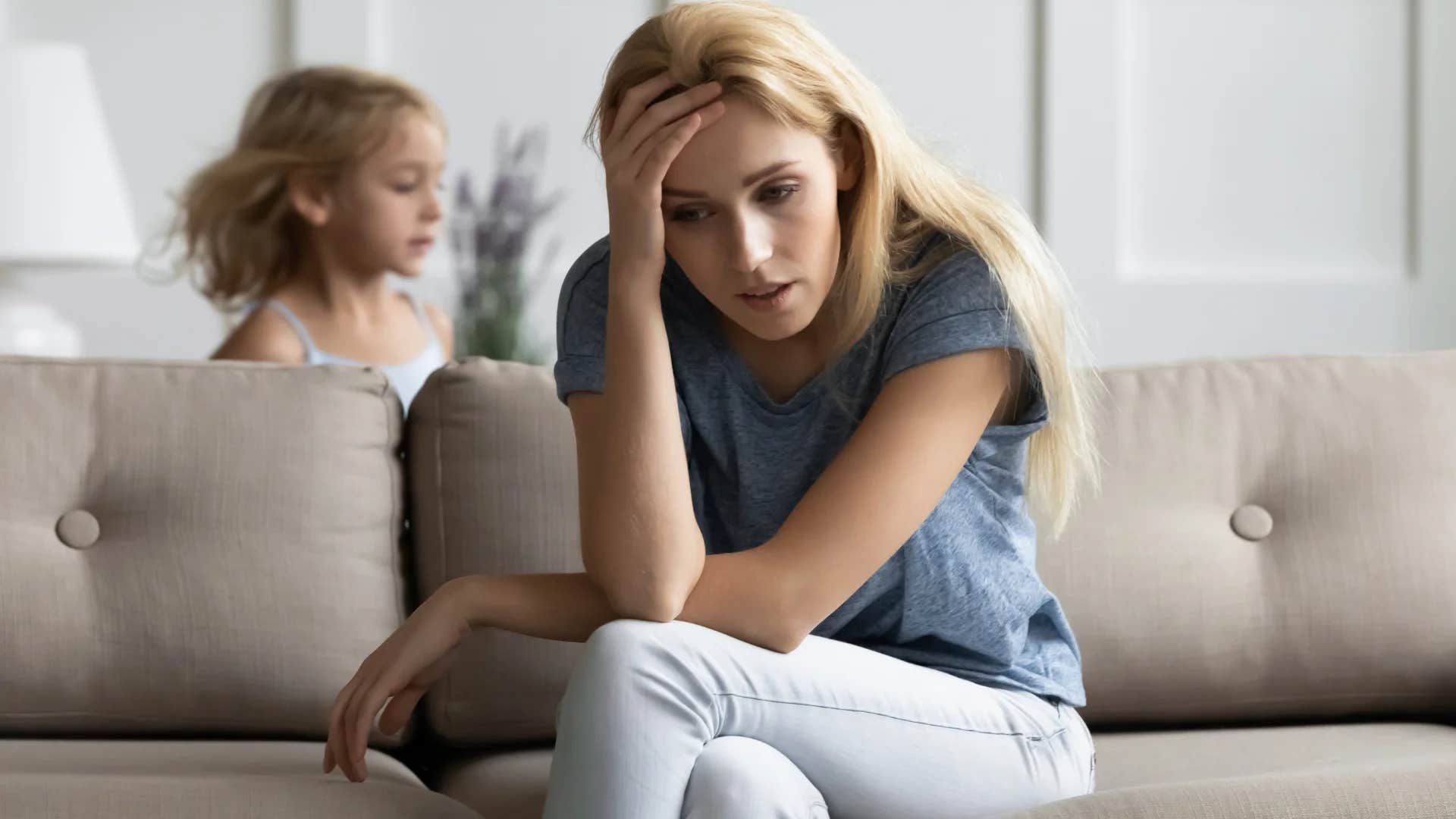 upset woman stressed thinking she's a bad mom