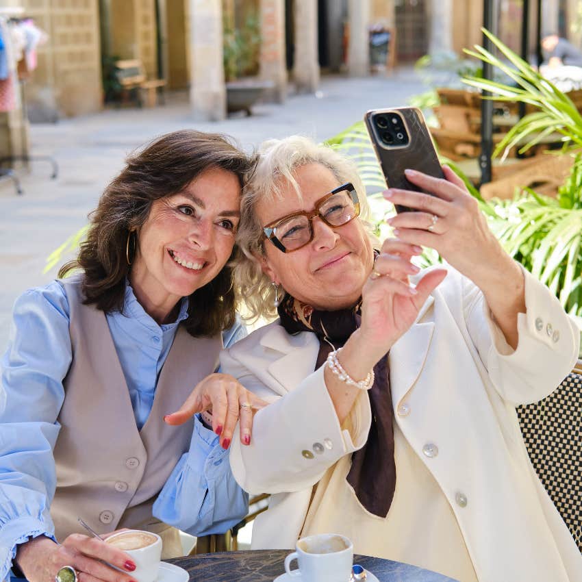 two women taking photo while on vacation