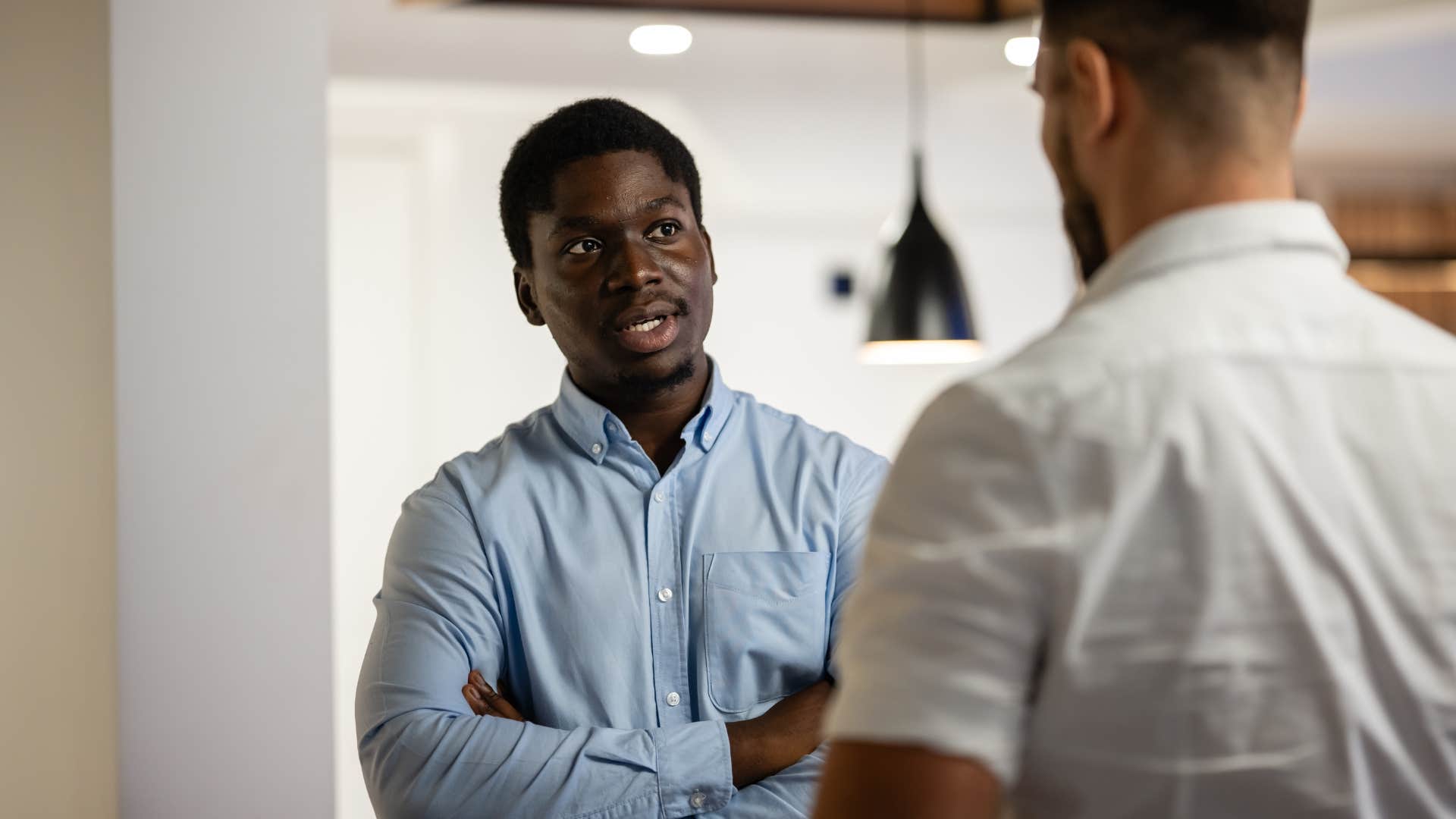 man with self-control telling colleague i'd rather handle this right now