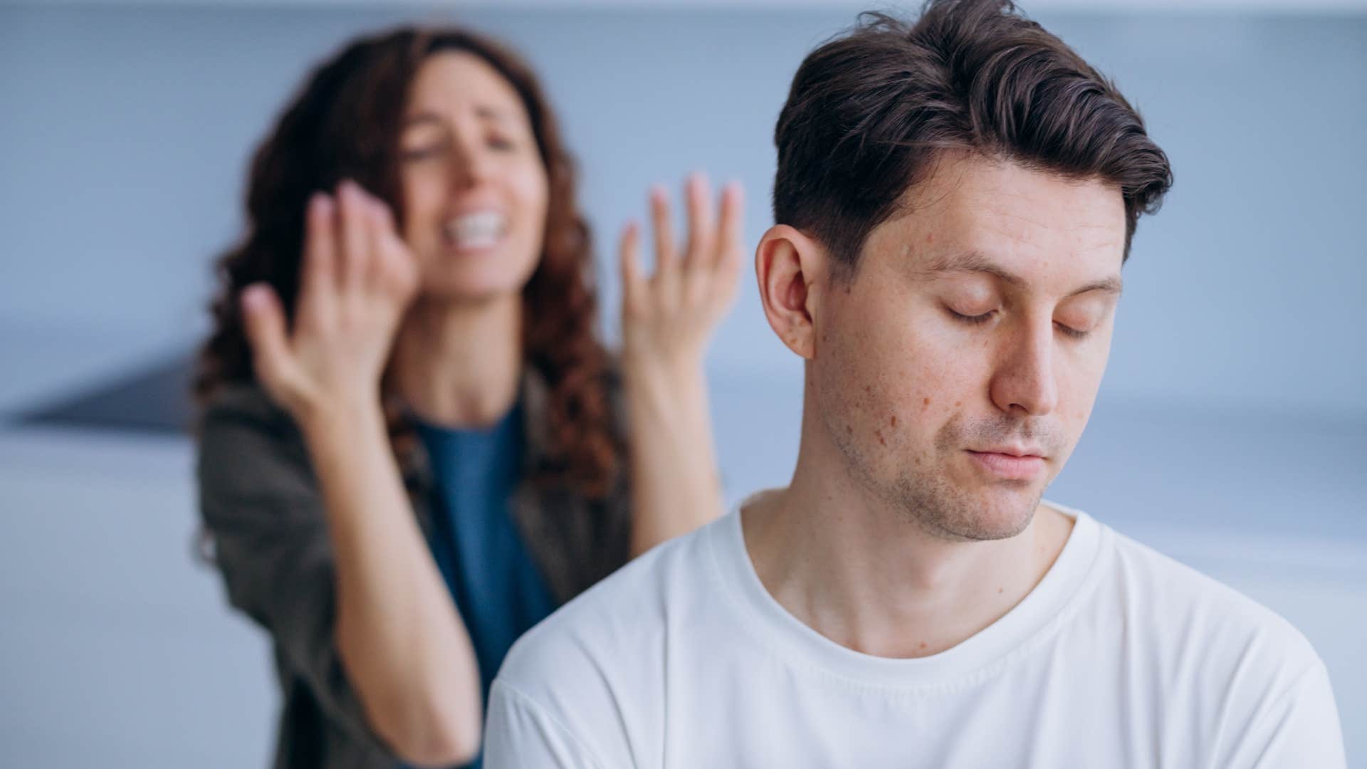 man turned away from woman upset with him to meditate