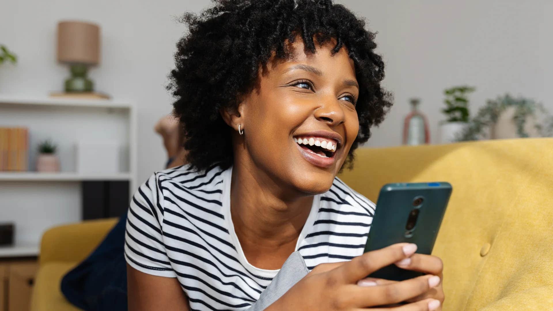 happy frugal woman deleting shopping apps from her phone