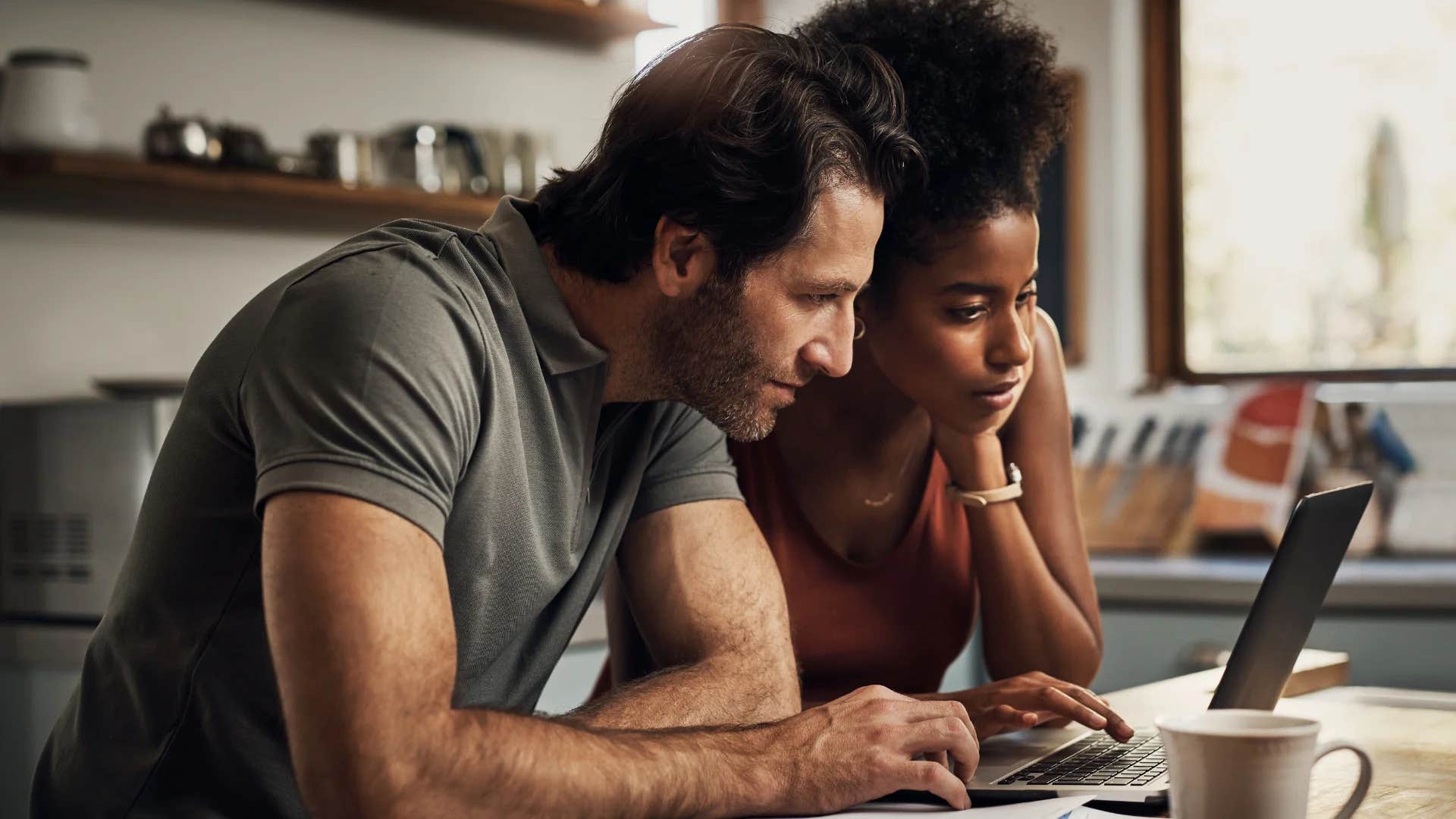 couple looking at their savings after putting money away