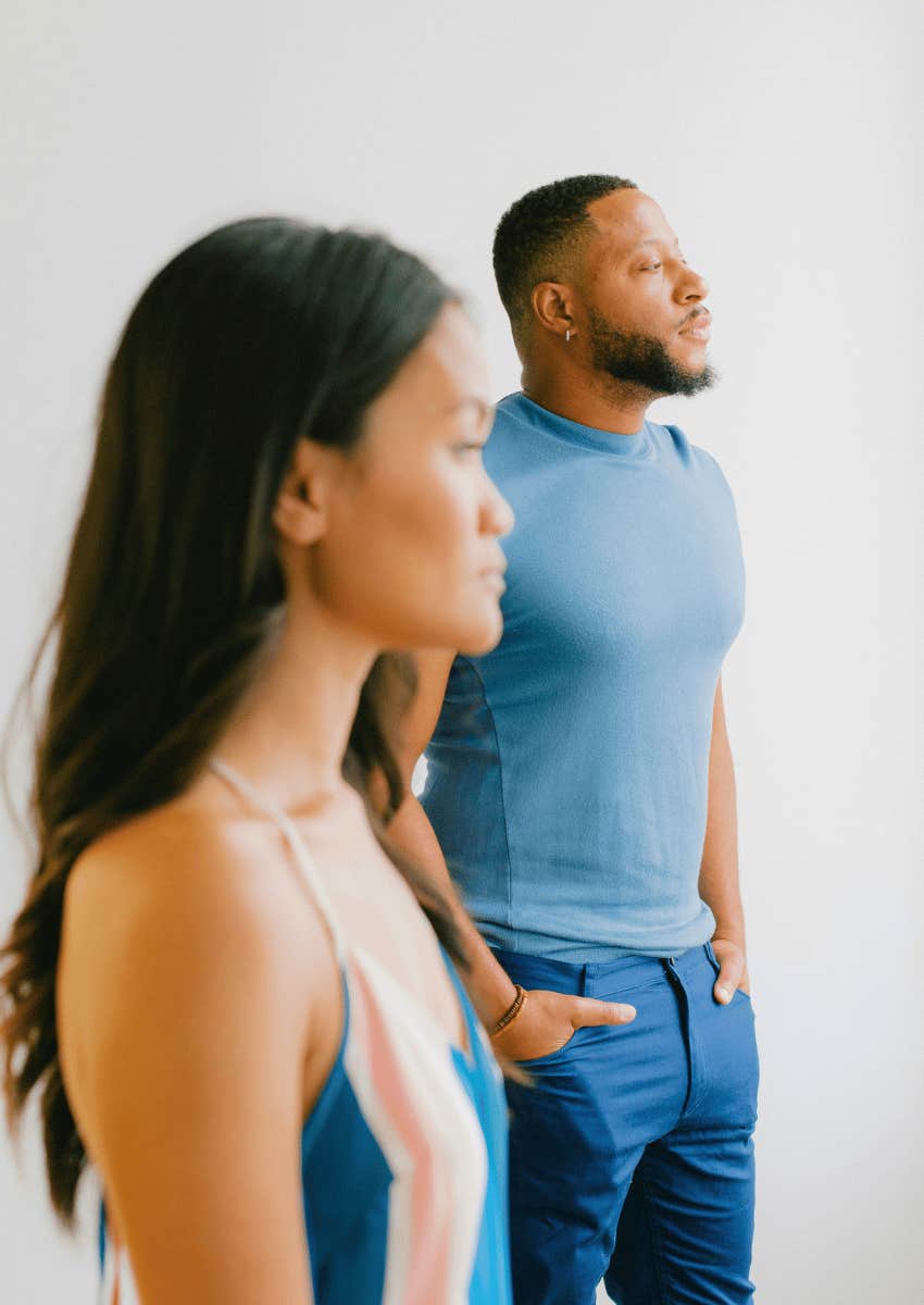 couple standing apart and looking away from each other