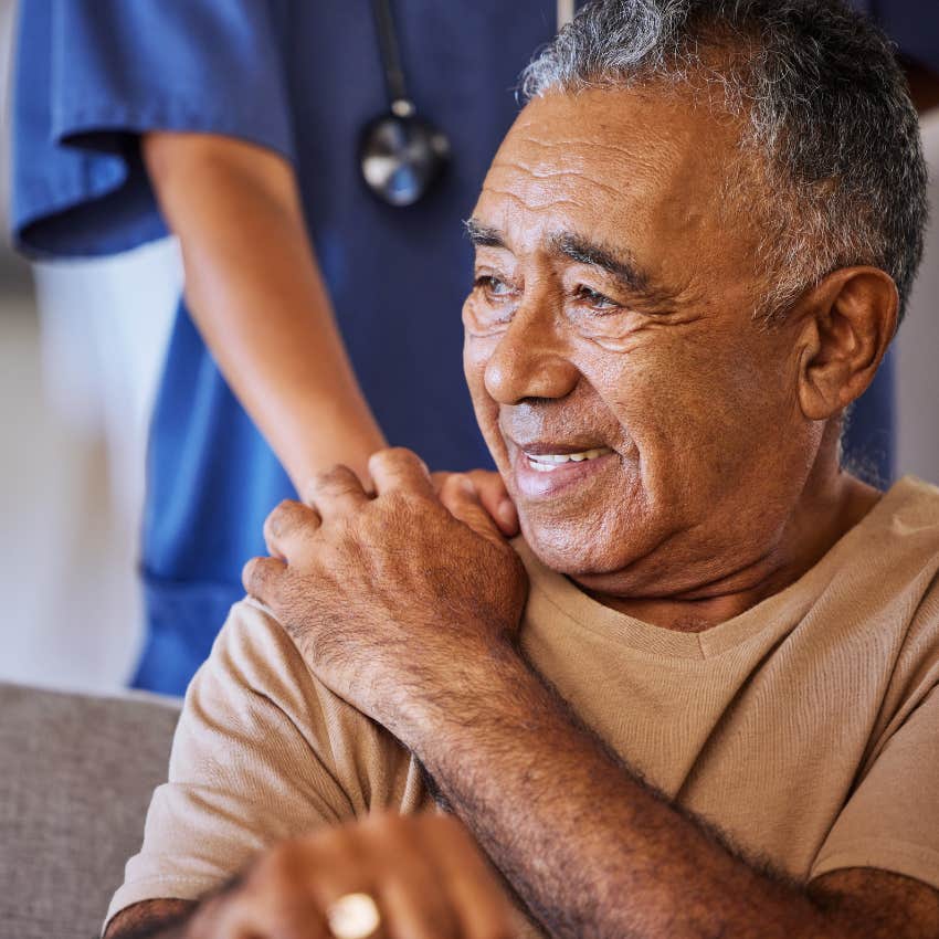 nurse with her hand on elderly man's shoulder