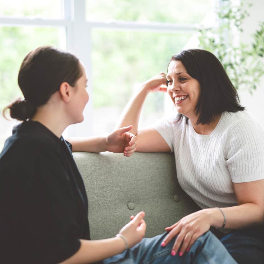 happy mom and teen daughter talking on couch mom manifested her teens good behavior