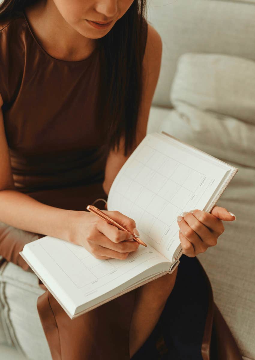 extremely productive woman honoring her natural rhythm using planner