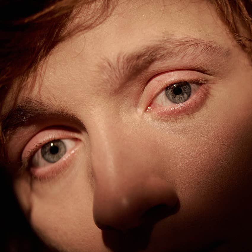 closeup of man with blue round eyes