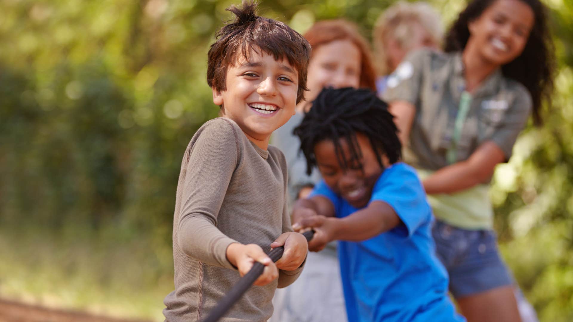 kids at summer camp playing tug of war