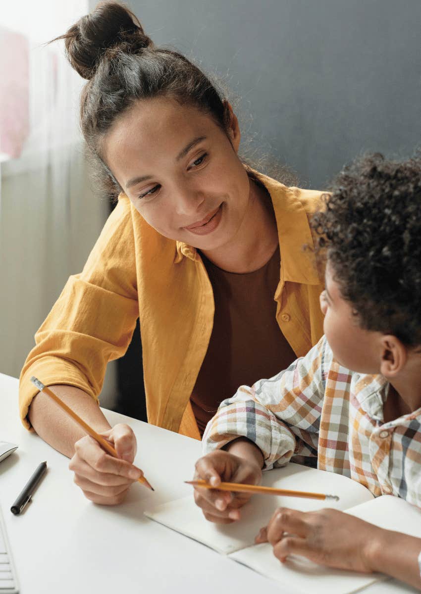 female teacher working with single student