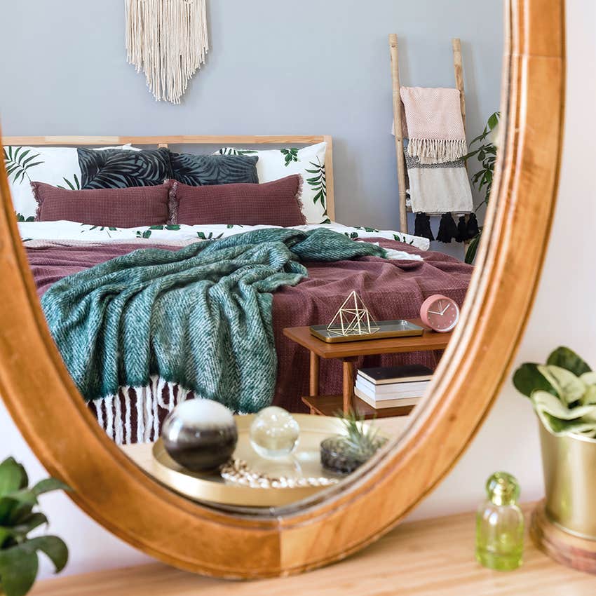 mirror across from bed 