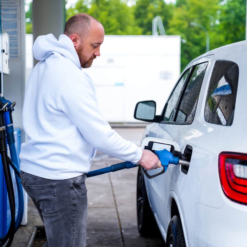 man filling tank at gas station struggling because iran war has increased prices