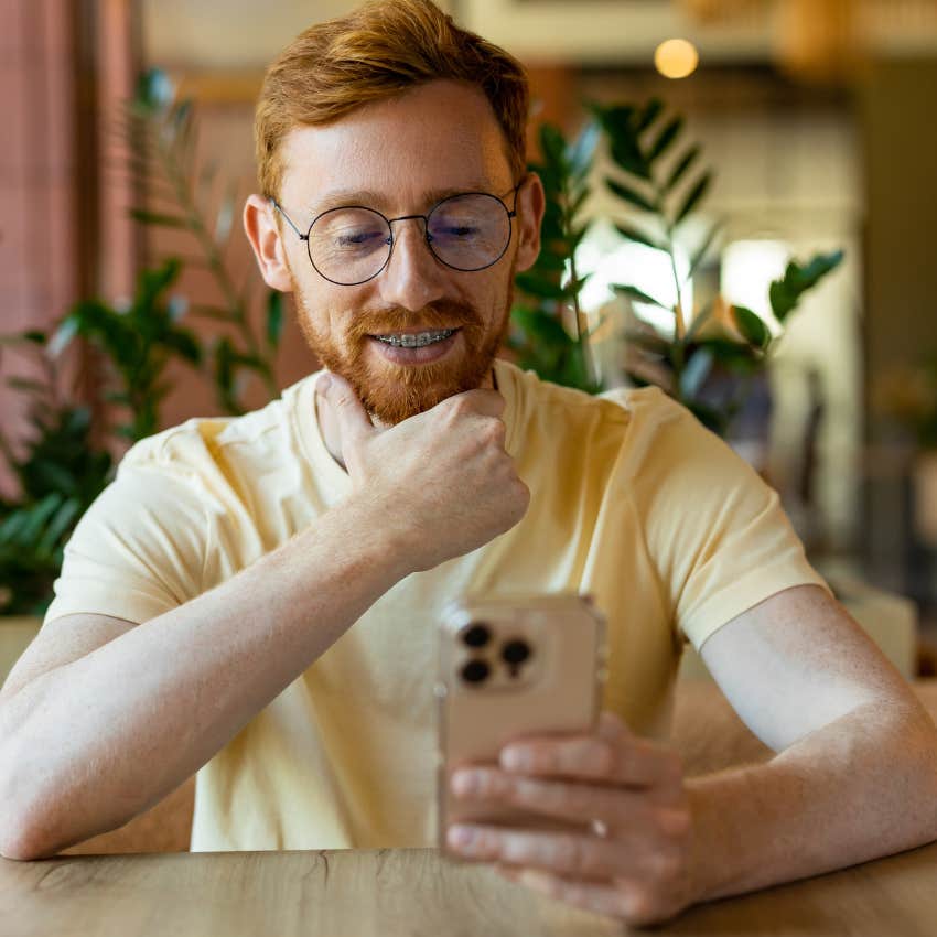 gen z man using TikTok for news and information looking at phone