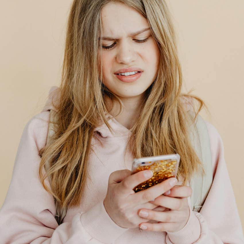 teen girl cringing at what her parents posted online about her