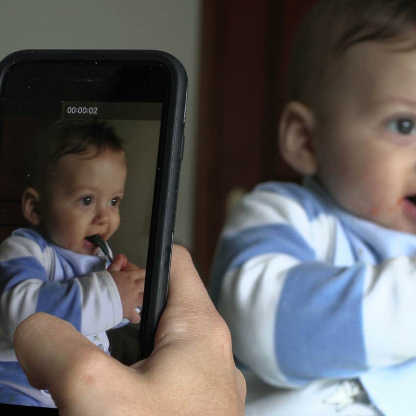 parent taking a picture of their baby to post online