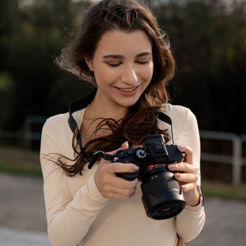 smiling woman holding camera outside understand the geometry of images