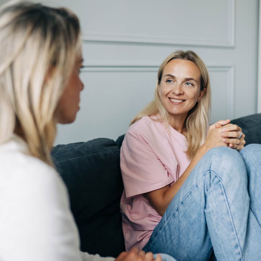 woman laughing at friend making jokes at her expense during conversation