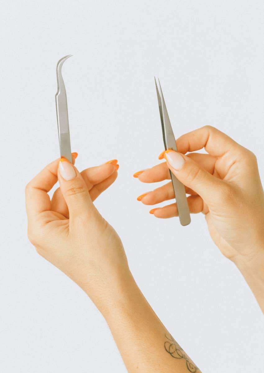 hands holding two kinds of tweezers