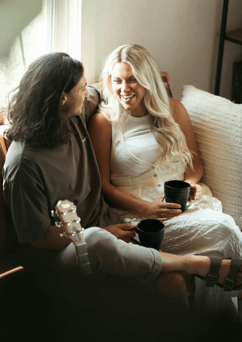 happy couple talking on couch