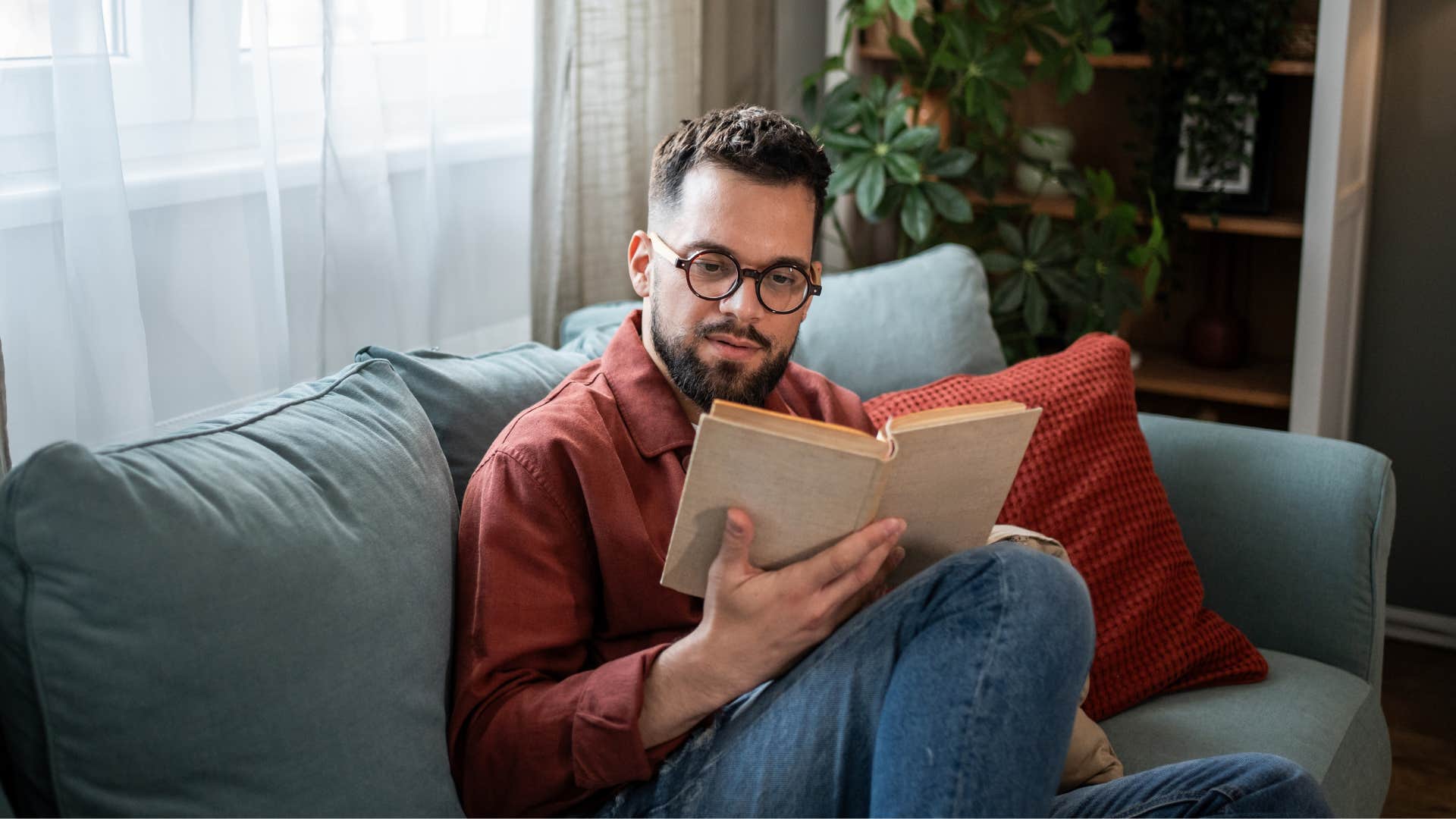 happy man reading a book not distracting himself with mindless tv