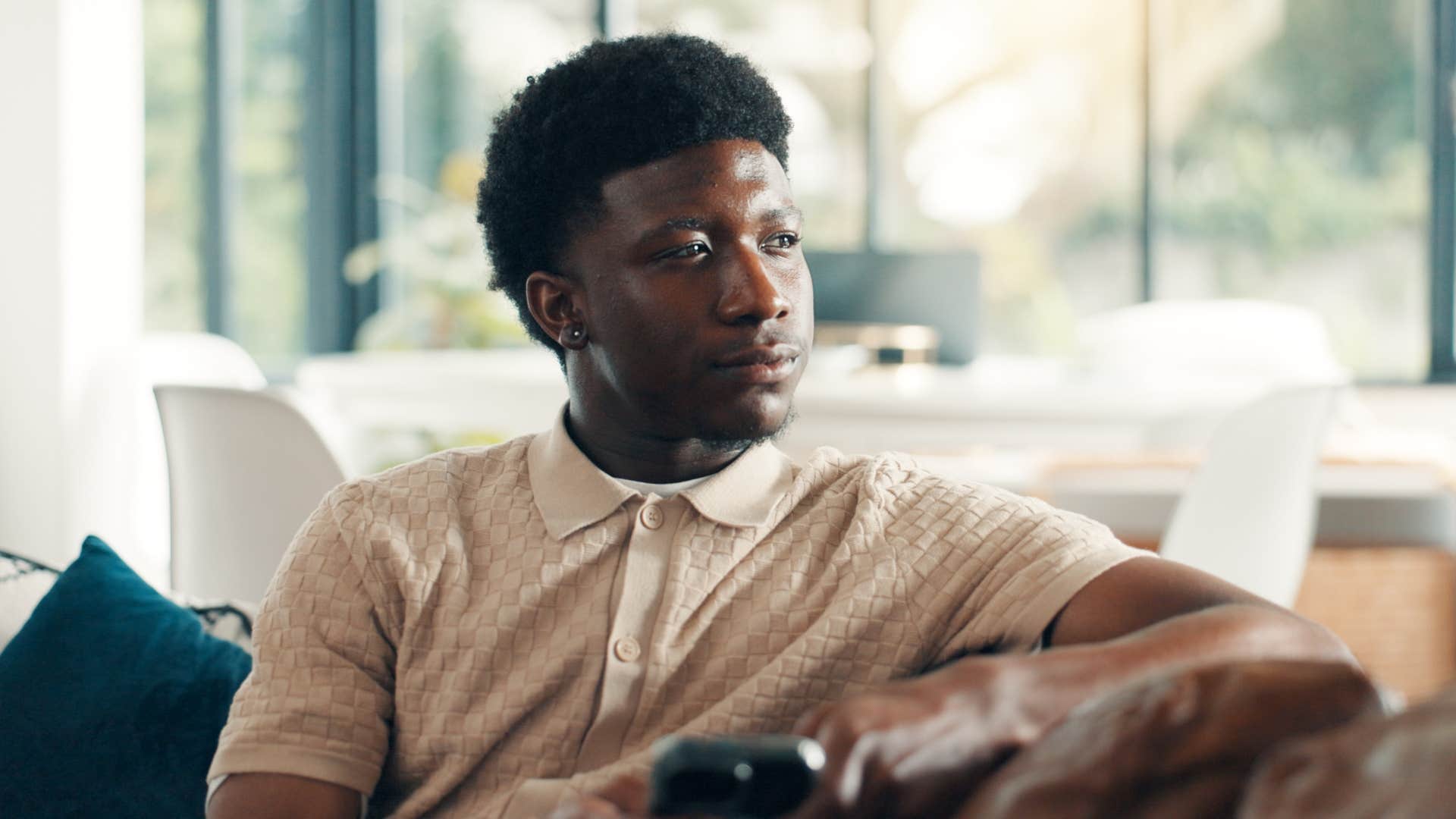 happy man sitting at home not caring what other people think