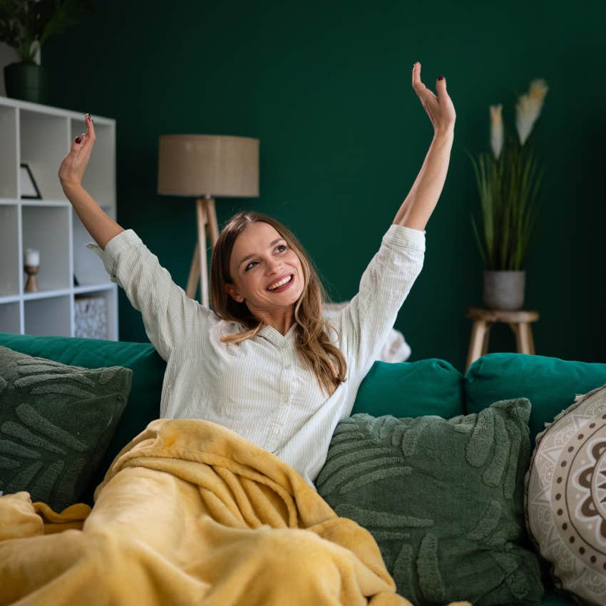 happy woman stretching and resting at home