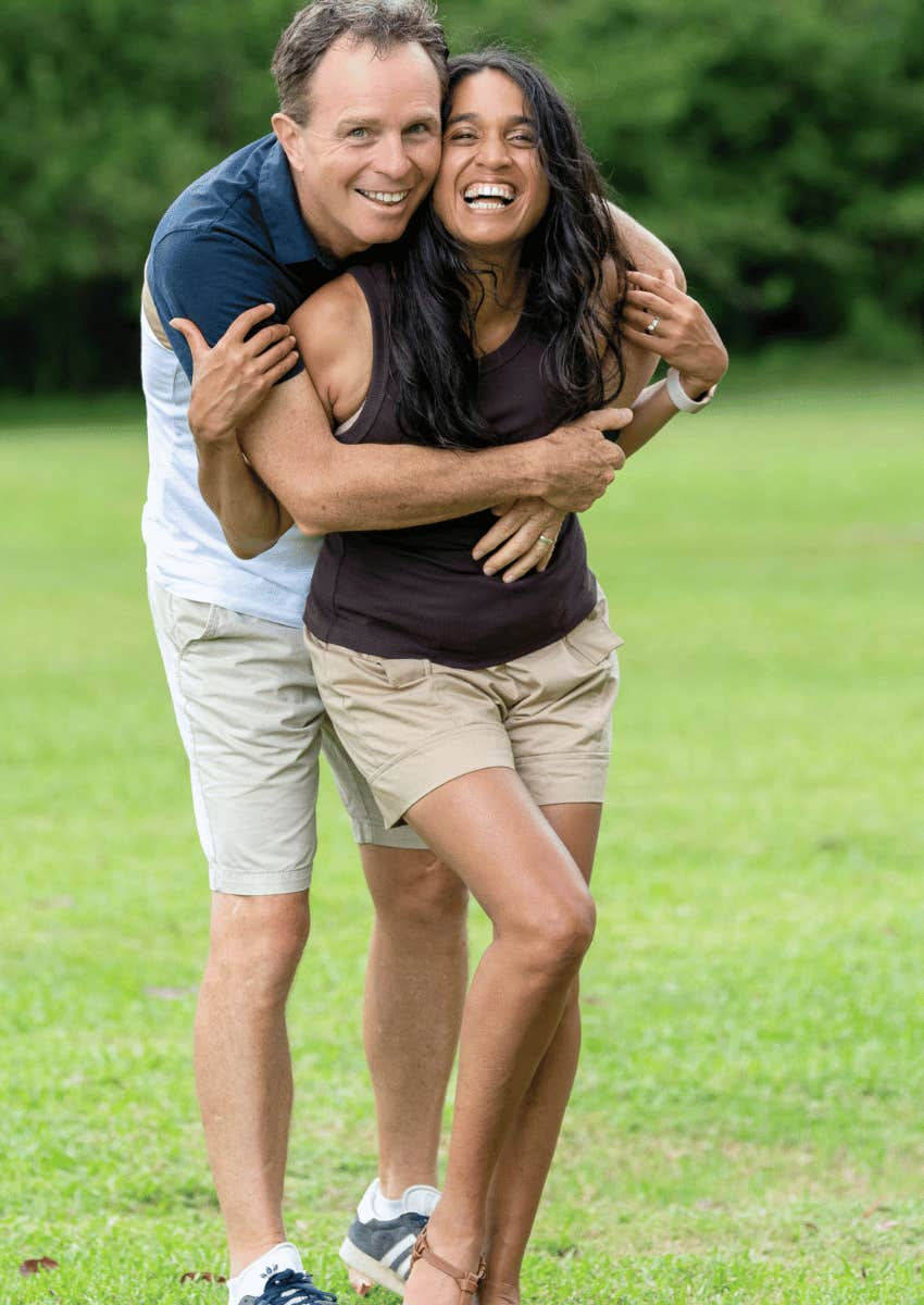 happy respectful couple laughing and hugging together