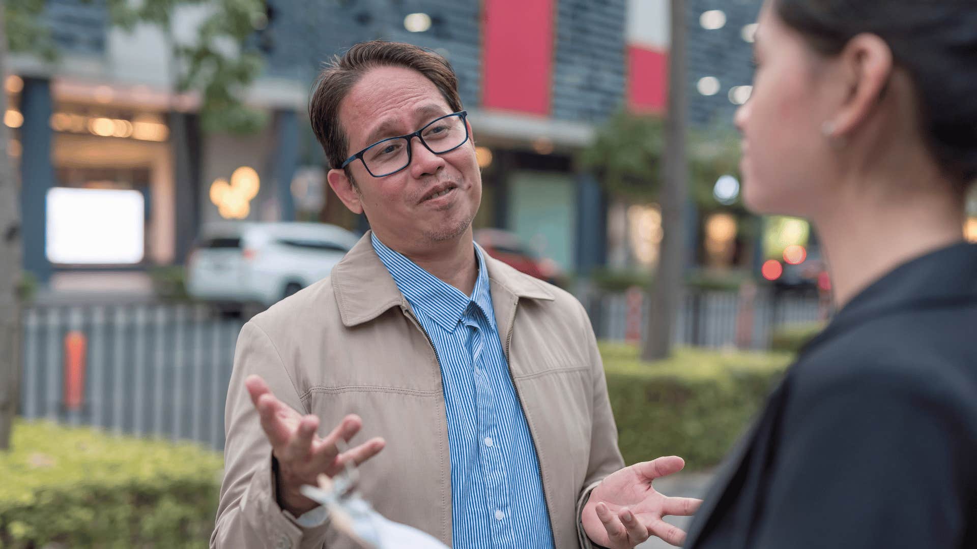 businessman bragging to colleague outside