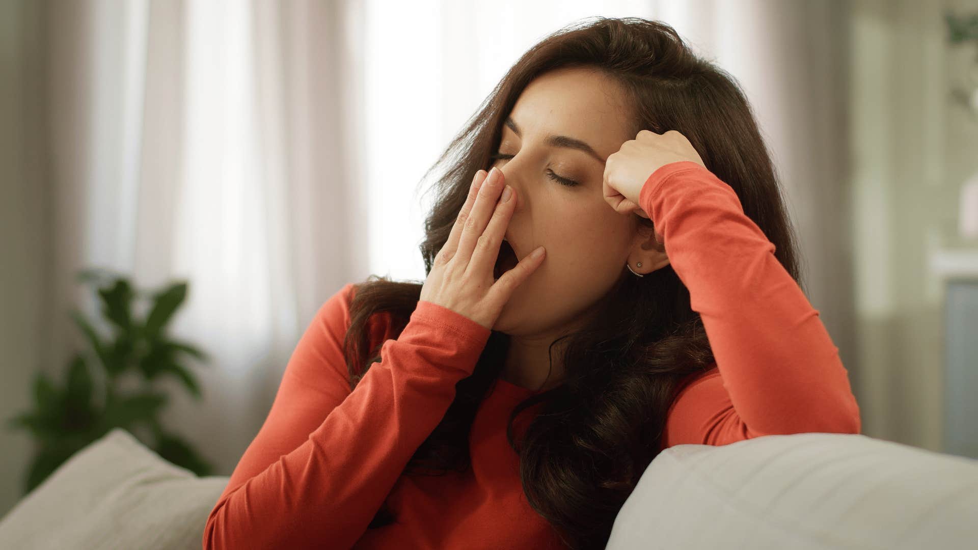 high iq woman yawning not wanting to attend social plans