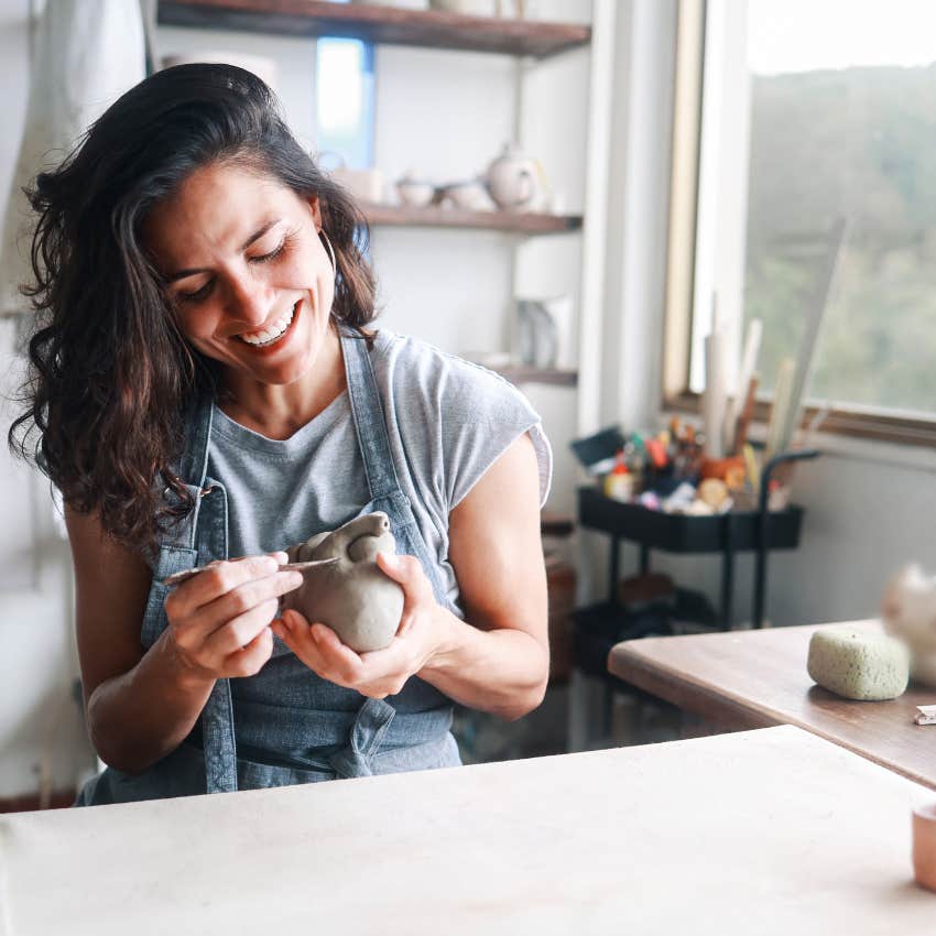 smiling woman while she reconnects with her original spark
