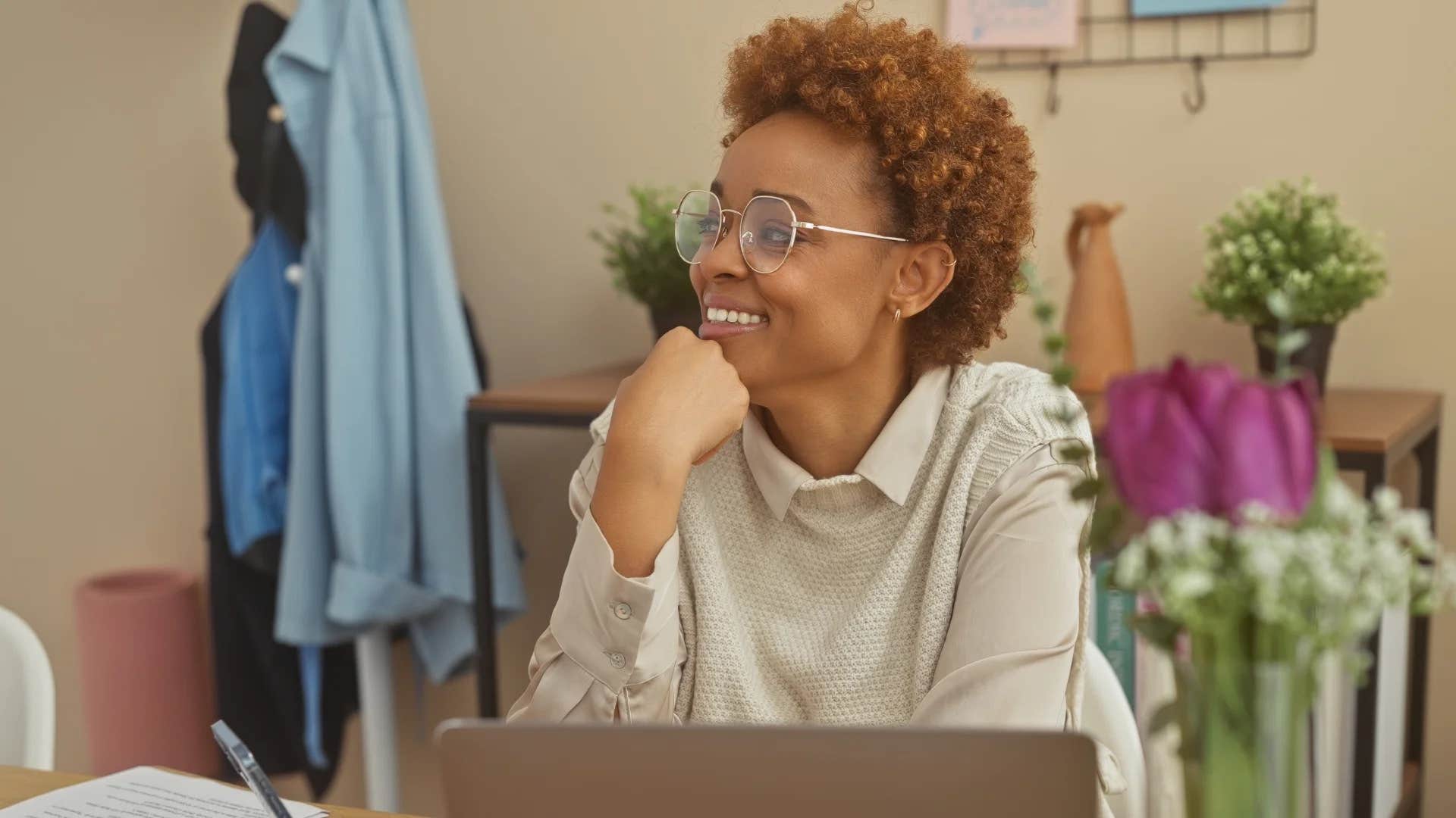 high iq woman smiling around clutter in her home
