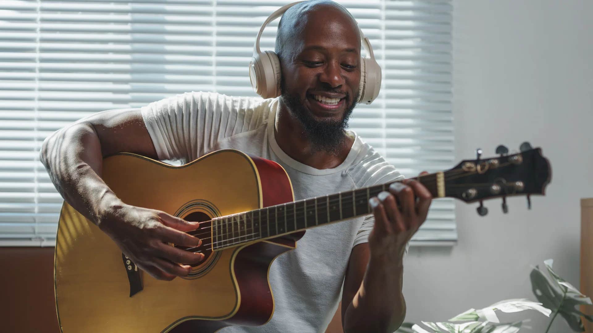 intelligent man playing guitar and singing