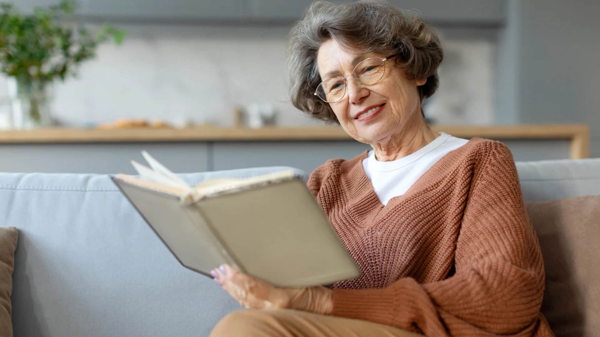 intelligent woman reading a book in her home