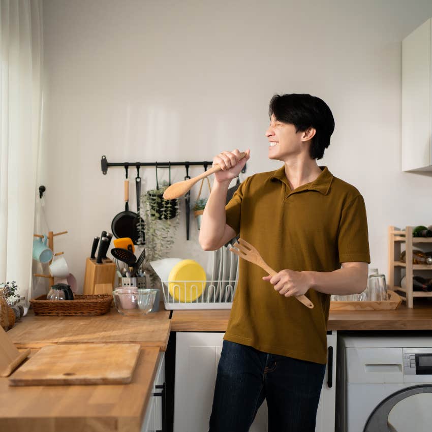 man singing and dancing in kitchen