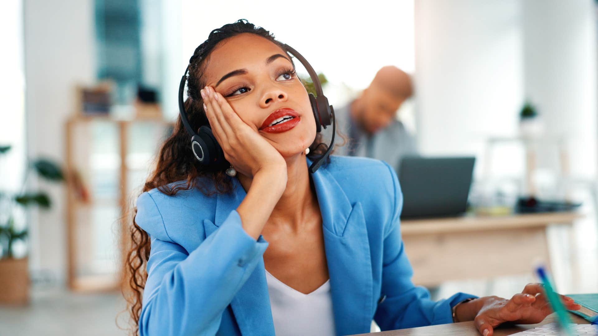 bored woman wearing headset having a low tolerance for mindless chatter