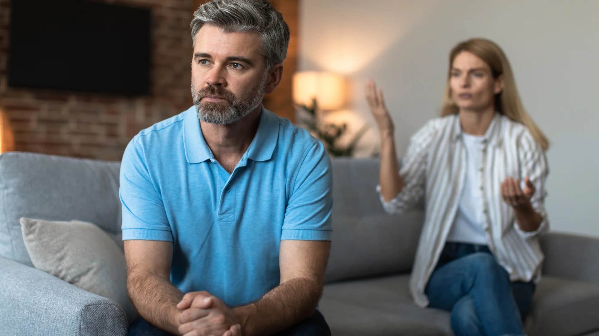 man turned away from his wife who feels uncertain about the future