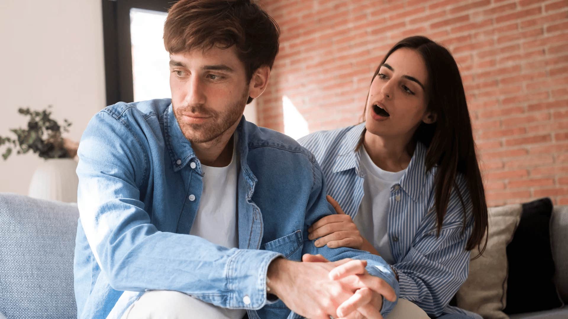 woman annoyed with disengaged husband talking about his mistakes