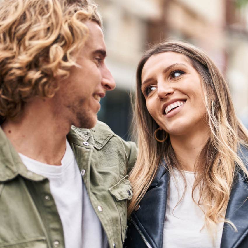 Couple in new relationship gazing at one another with attraction