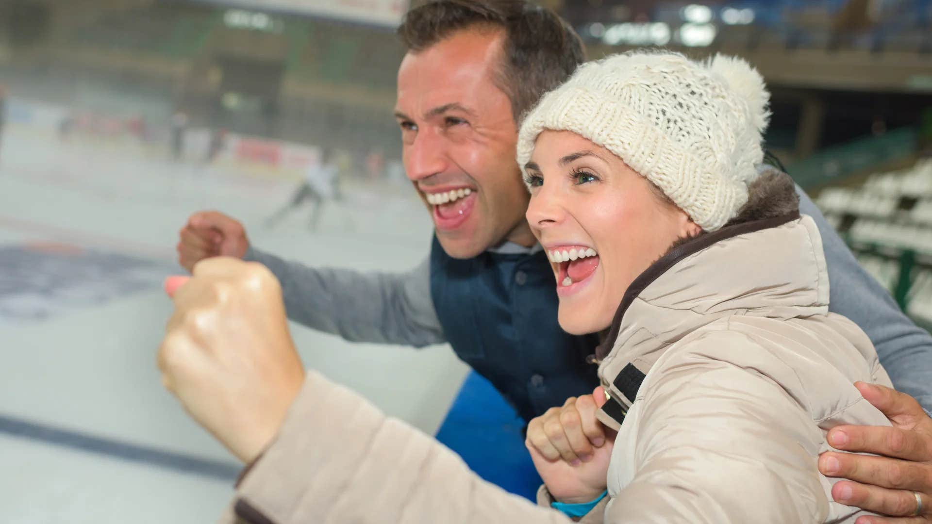 parents cheering on child playing hockey