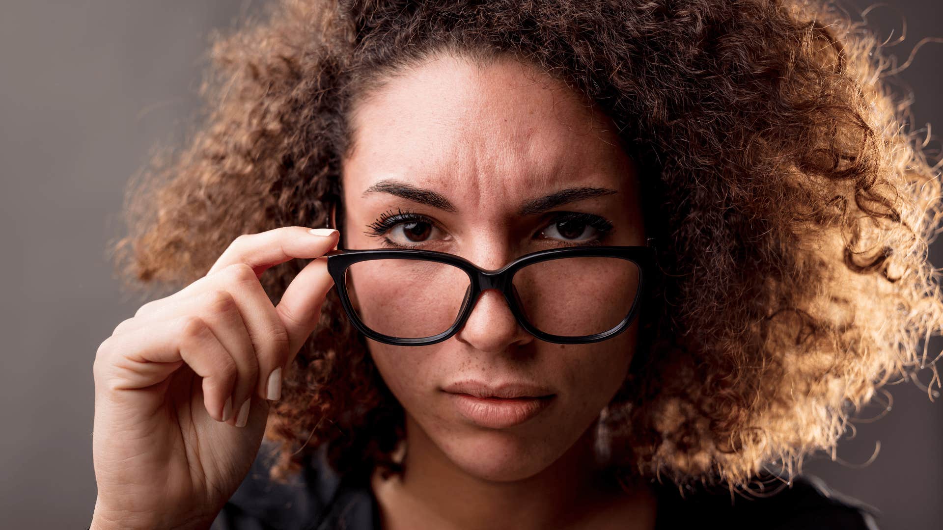 hypervigilant woman putting her glasses down