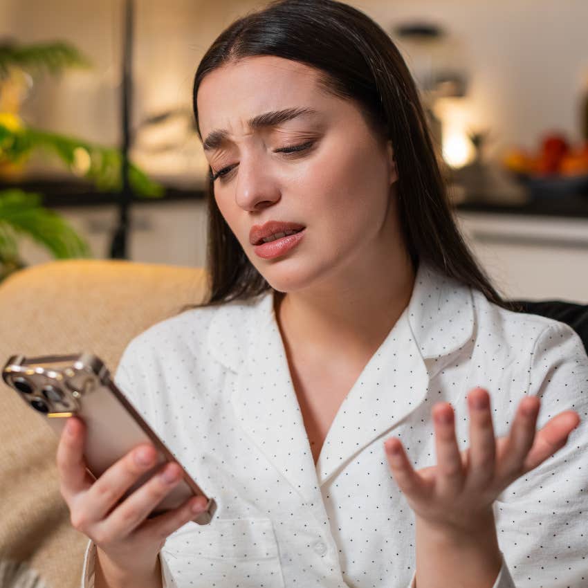 upset woman saying that's not fair while looking at her phone
