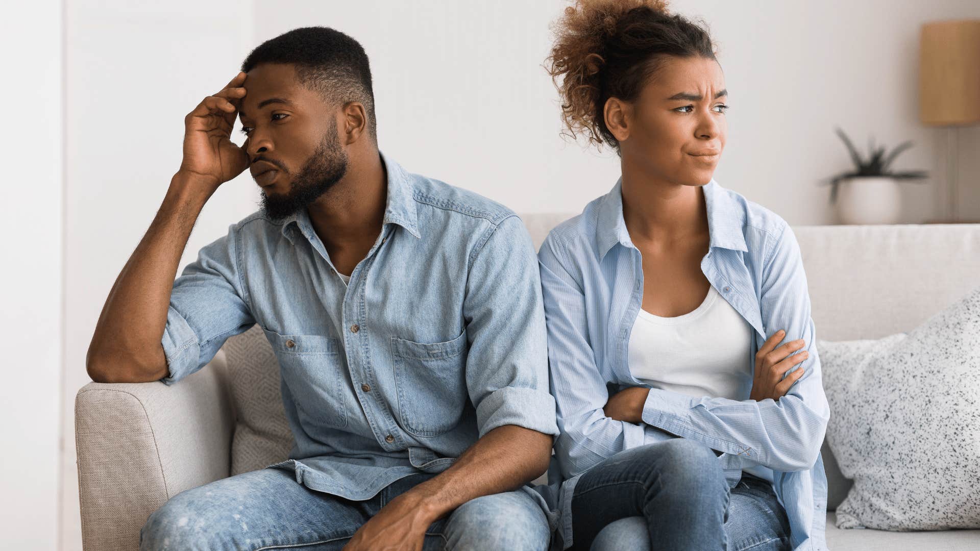 couple display intimacy issues by avoiding each other on the couch