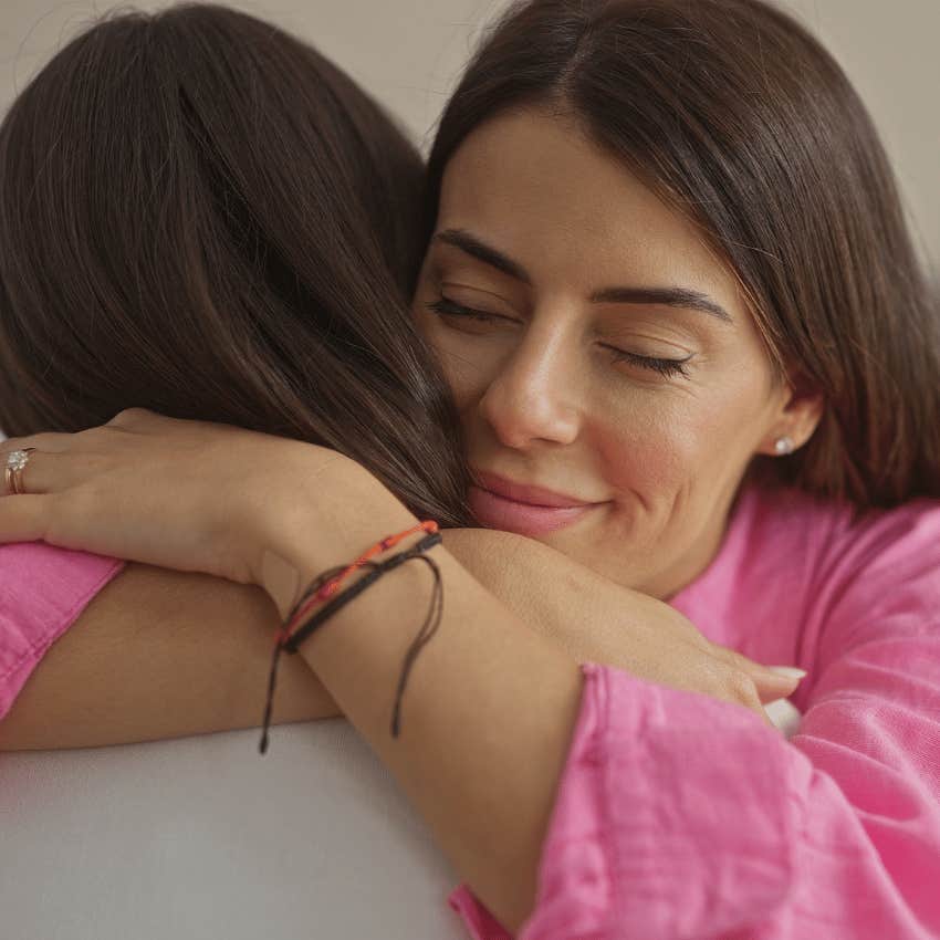 woman carrying emotional labor hugging her friend