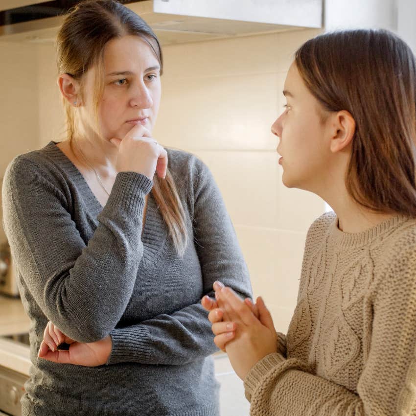 Woman saying "I guess so" to her daughter at home.