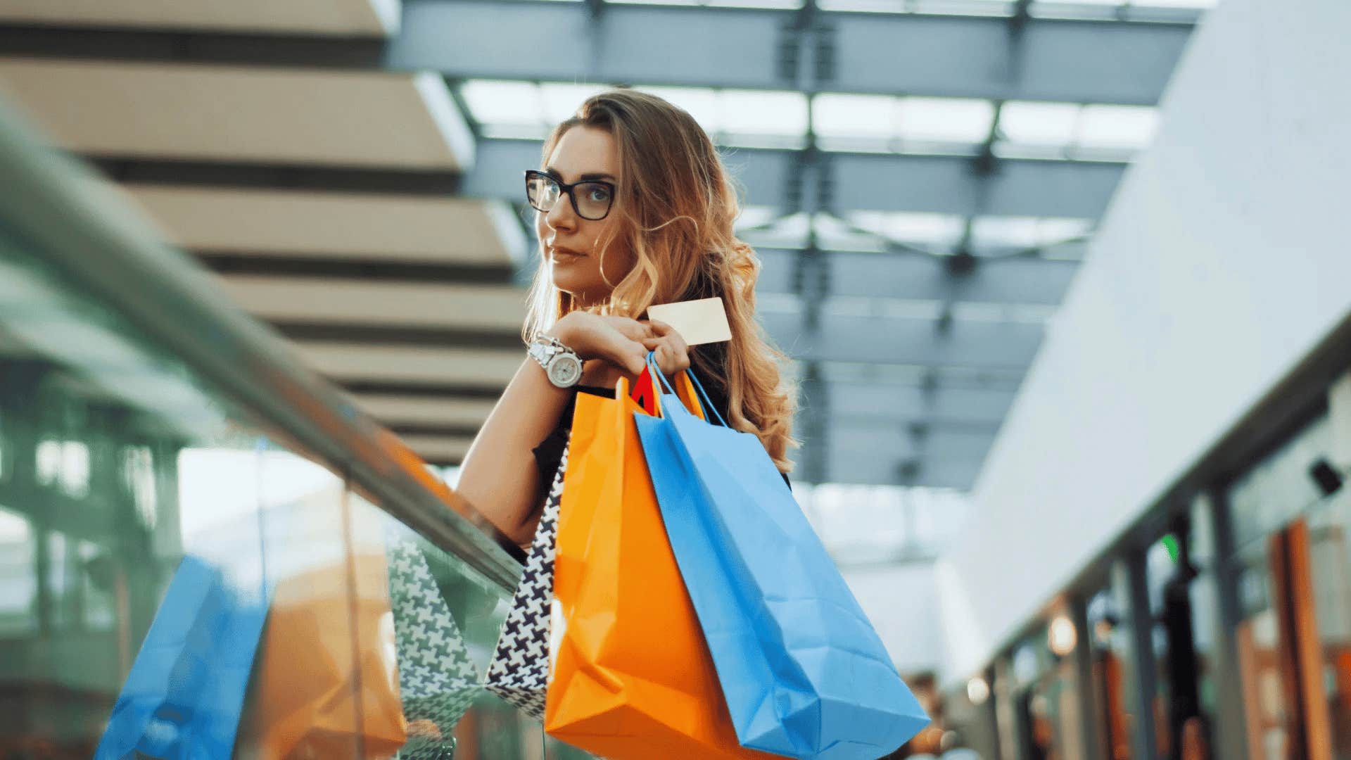 woman holding shopping bags saying i can figure out my finances later