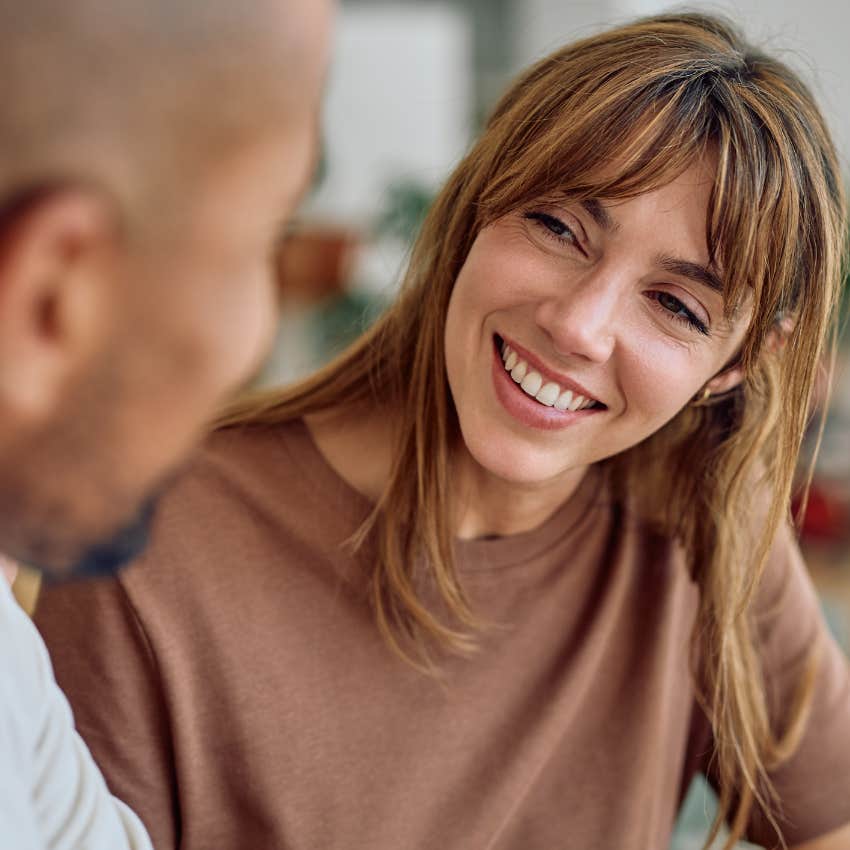 introverted woman who makes people feel valued smiling at her partner