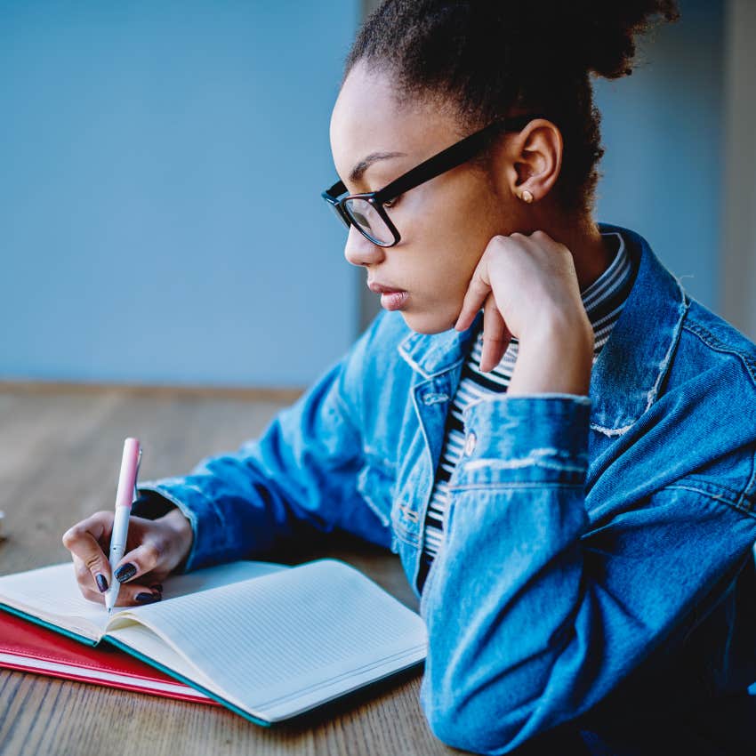 woman writing in notebook