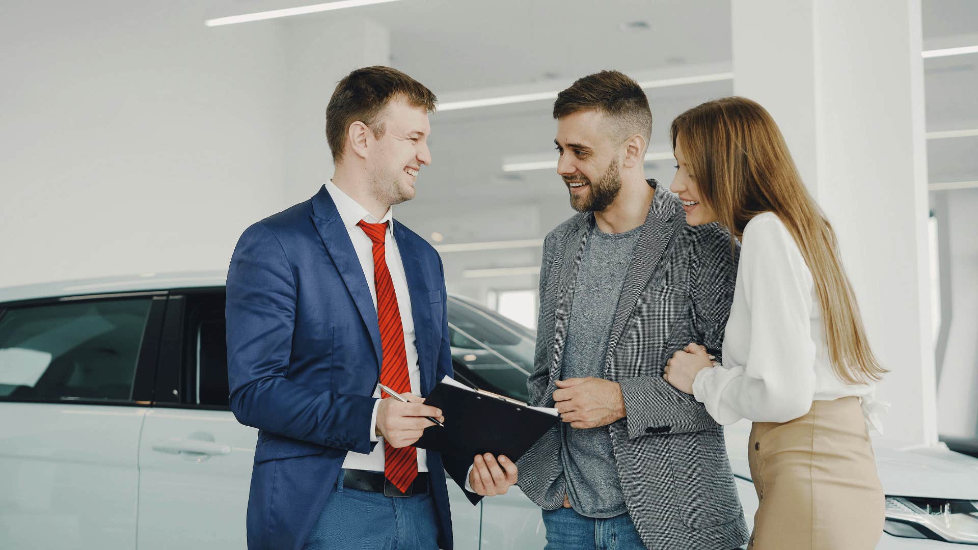 couple with no money buying an extended warranty for their new car